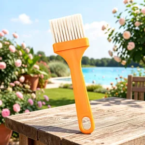 Detailed view of the yellow handle baking and cleaning brush with dense white bristles.
