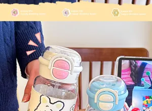 Süße Glaswasserflasche mit Strohhalm, Lederschutzhülle und Skala. Detailaufnahme.