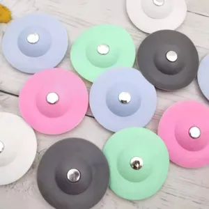 Silicone floor drain cover detail view, showing various color options and flexible saucer shape.