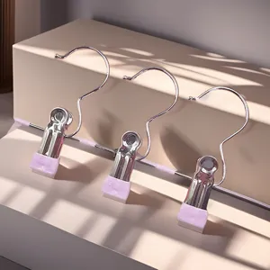 Stainless steel pants clips and hat drying hangers with pink non-slip coating for home use.