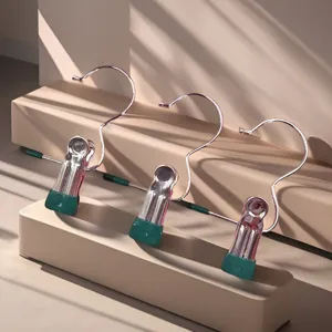 Stainless steel hook clips with green non-slip tips, detailed view for clothing and sock hanging.