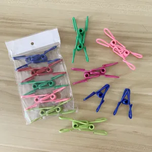 Detail view of colorful stainless steel clothespins, showing various colors and packaging.