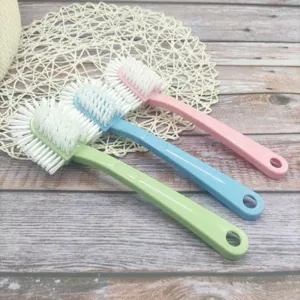 Multi-functional shoe brush detail showing three colorful long handle brushes with hard bristles.