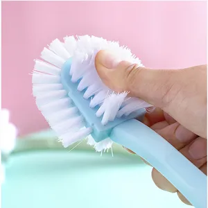 Durable multi-functional five-sided shoe brush with hard white bristles and long handle.