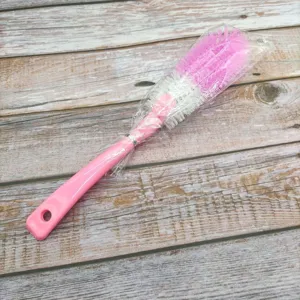 Long handle cleaning brush with pink handle and dense bristles for deep cup and bottle washing.