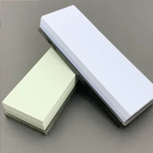 Detailed view of dual-color sharpening stone blocks with non-slip bases for kitchen use.