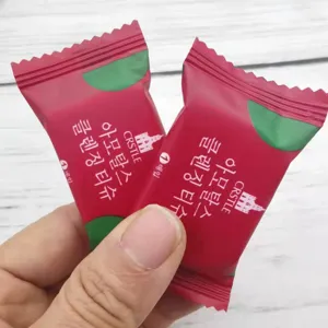 Detail view of portable candy-shaped compressed facial cleansing towel for travel use.