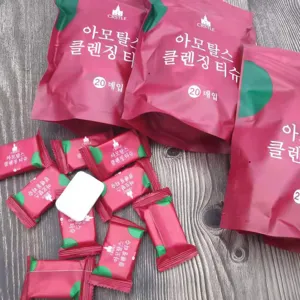 Detailed shot of disposable compressed facial towels in candy-like packaging and pouches.
