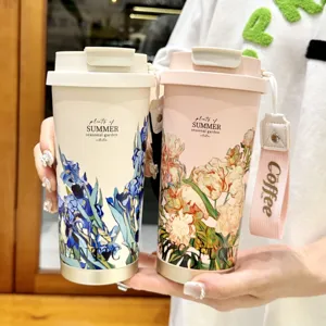 Stylish dual-drinking vacuum insulated coffee mug with portable strap and floral design.