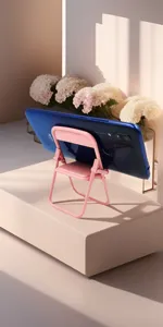 Mini folding chair phone stand detail view, cute macaron pink desktop holder display.