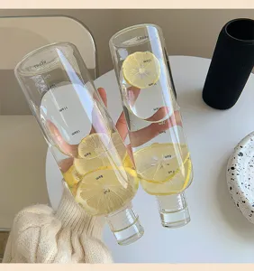 Ins style transparent glass water bottle with time marker and fresh lemon slices for daily use.