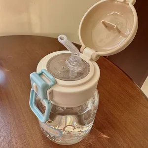Close-up of cute floral straw water bottle with secure pop-up lid and vibrant design details.