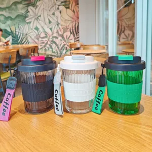 Portable glass coffee cup with silicone sleeve and lanyard for daily office use and travel.