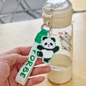 Nahaufnahme des tragbaren Kunststoff-Wasserflaschenriemens und süssen Panda-Anhaengers.