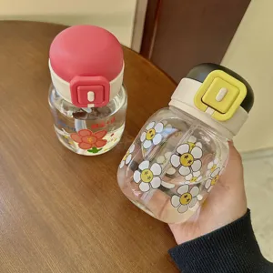 Cute fat water bottle with straw, transparent glass cup with cute flower print and flip lid.