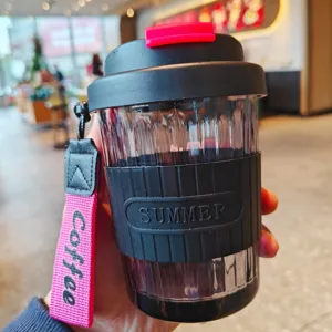 Portable glass coffee cup with silicone sleeve and lanyard, heat resistant, ideal for daily use.
