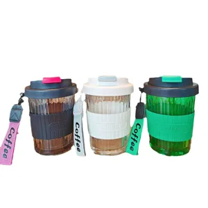 Portable glass coffee cup set with silicone sleeve and strap, stylish heat resistant water mug.