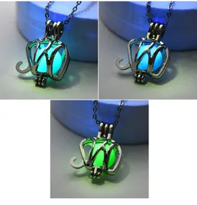 Glowing elephant pendant necklace detail showing luminous glowing bead effect in the dark.