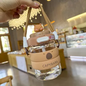Cute capybara glass straw cup detail view, portable brown silicone sleeve and cute lid.