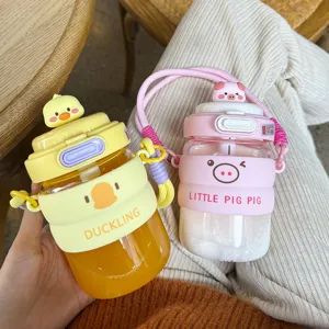 Cute cartoon duck and pig glass water bottle with straw and portable strap for students daily use.