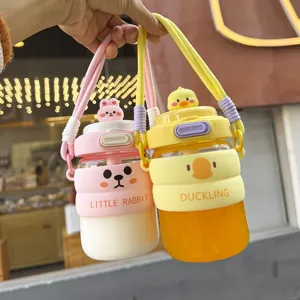 Cute cartoon glass water bottle with silicone protective sleeve and straw for daily use.