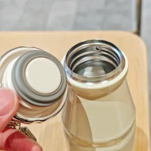 Close-up of the portable mini milk thermos bottle opening and sealing cap structure.
