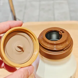 Stainless steel thermos cup detail view, showing inner lid and vacuum insulated liner design.