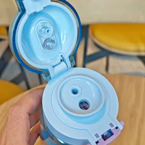 Detailed view of the light blue student water bottle lid showing dual-drink straw structure.