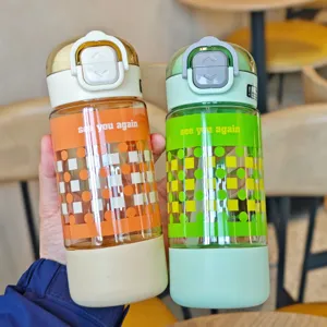 Detailed shot of portable plastic straw water bottles with colorful geometric print and base.