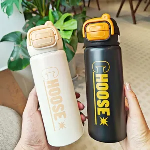 Stainless steel vacuum insulated water bottle with dual drinking lid and portable handle.