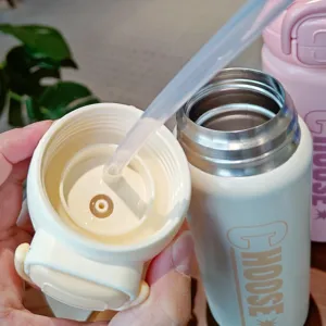 Detailed close-up view of stainless steel thermos water bottle lid and straw design.