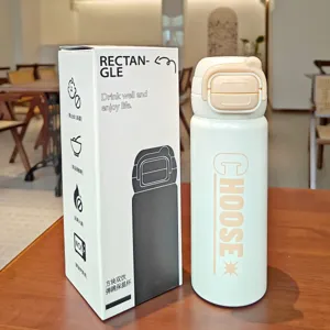 Stainless steel thermal water bottle with dual-drink pop-up lid and portable handle.