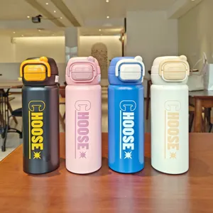 Stainless steel vacuum insulated water bottle with dual drinking lid and portable handle.