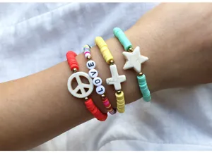 Colorful polymer clay beaded stackable bracelets set with peace, cross and star charms for women.