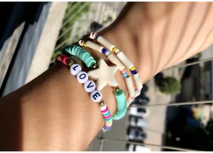 Colorful clay bead bracelet detail with star charm and love letters for women fashion styles.