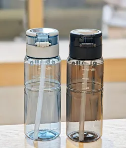 Portable plastic water bottle with straw, dual-drinking design, clear capacity scale marks.