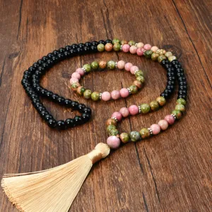 Detail view of natural stone beaded necklace and bracelet set with elegant tassel and metal spacers.