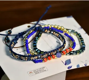 Close-up detail of the blue handmade Miyuki seed bead layered bracelet with delicate sparkling crystals.