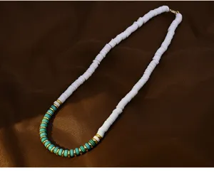 Close-up detail shot of the stylish polymer clay bead necklace featuring vibrant turquoise and white design.
