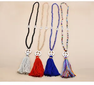 Handmade crystal beaded long sweater chain necklace with peace sign pendant and tassel decor.