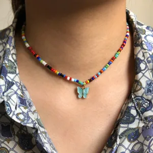 Close-up of colorful seed bead choker necklace with cute light blue butterfly pendant.