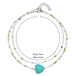 Detailed view of double-layer colorful seed bead necklace with turquoise heart pendant and chain.