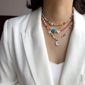 Colorful seed bead layered necklace with daisy pendant, bohemian pearl choker detail view.