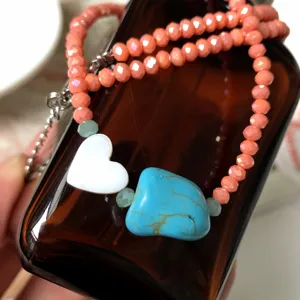 Colorful beaded necklace with white heart and turquoise stone pendants for summer fashion.