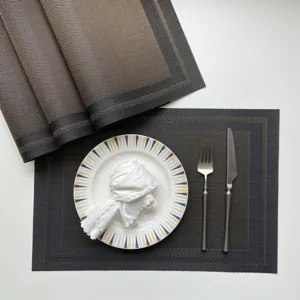 Detail shot of luxury PVC woven placemat set with stylish table setting accessories.