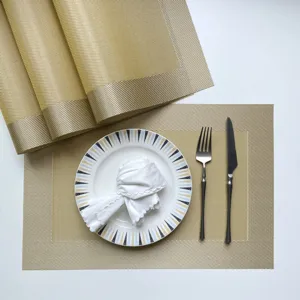 Detail view of golden PVC woven placemat set, non-slip heat resistant dining table mat.