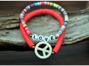 Detailed view of colorful polymer clay bead bracelets featuring letter love beads and peace pendant.