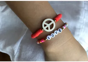 Colorful polymer clay bead bracelets detail shot featuring a peace sign and love letters.