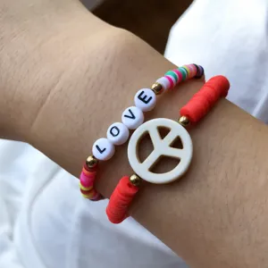 Colorful polymer clay heishi bead bracelet set with love letter beads and peace sign charm.
