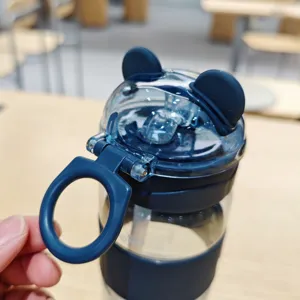 Nahaufnahme der dunkelblauen Kunststoff-Strohhalmflasche mit süßem Bärenohren-Deckel und Griff.